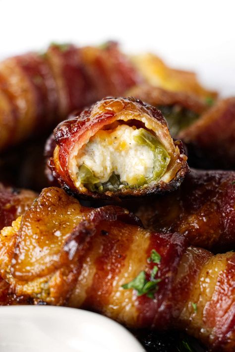 Traeger jalapeno poppers are the perfect party snack. They are stuffed with cheese, wrapped in bacon, and finished with a maple glaze. Stuffed Jalepeno, Bacon Wrapped Figs, Wrapped Jalapeno Poppers, Bacon Jalapeno Poppers, Traeger Grill Recipes, Smoked Jalapeno, Bacon Wrapped Jalapeno Poppers, Bacon Wrapped Jalapenos, Pellet Smoker