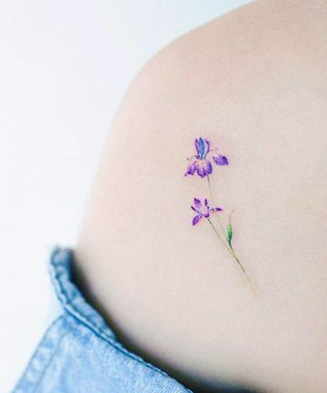 Dainty shoulder tattoos These dainty details are sure to wow. Dainty Iris Tattoo, Larkspur Tattoo Simple, Dainty Shoulder Tattoo, Iris Flower Tattoo, Violet Tattoo, Cool Shoulder Tattoos, Iris Tattoo, Small Shoulder Tattoos, Flower Tattoo Shoulder