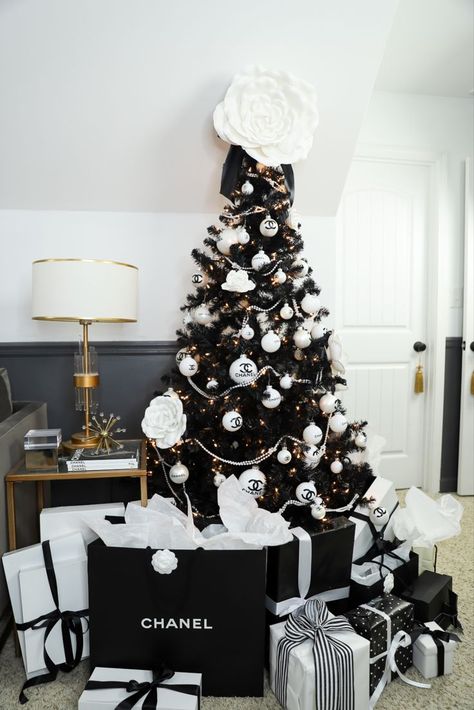 This DIY Chanel themed Christmas tree I made for my den is the ultimate girly glam tree I never knew I needed. Complete with the classic black and white color scheme, Chanel logo ornaments, white pearls, and Camellia flowers, it's my favorite tree in my house. Click thru to see how I made it, and check out my other 4 trees Chanel Inspired Christmas Decor, Chanel Theme Christmas Tree, Channel Christmas Tree, Coco Chanel Christmas Tree, Chanel Inspired Christmas Tree, Chanel Tree Christmas, Chanel Christmas Tree Ideas, Chanel Christmas Tree, Chanel Christmas