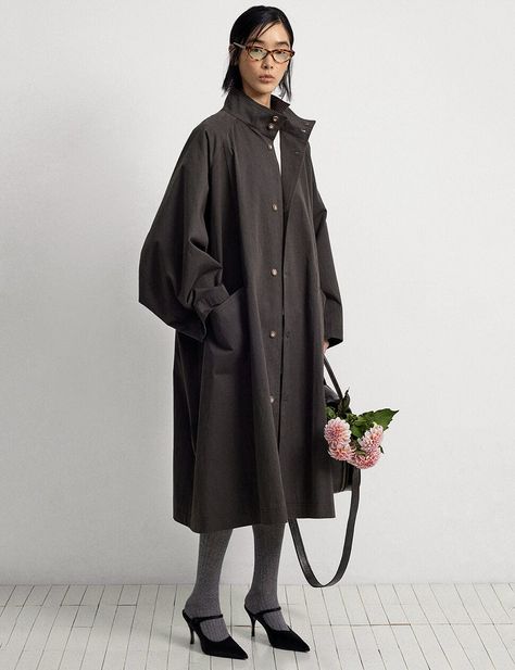 A woman stands on a white wooden floor. She wears a large dark grey coat, grey tights and black heeled shoes. In her hand she carries a bag with flowers coming out of the top. Street Style Winter 2024 Women, Flowy Jacket, Boxy Blazer, Cocoon Jackets, Pixie Market, Cocoon Coat, City Boy, Street Style Winter, Oversized Coat