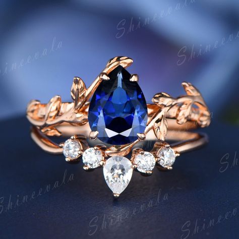 Blue sapphire ring, vintage engagement ring, rose gold wedding ring women, bridal set rings, bridal ring, promise ring, anniversary ring, anniversary gift This jewelry is made to order, it can be made with any gemstone/metals.  ITEM INFORMATION: Blue sapphire ring:  Metal Type: Sterling Silver/14K/18K  Band Width: About 1.3-1.4mm  Main Stone: 6x8mm Pear Cut Lab-created Blue Sapphire Wedding band:  Metal Type: Sterling Silver/14K/18K  Band Width: About 1.3-1.4mm  Main Stone: Round Cut & Pear Cut Blue Pear Sapphire Engagement Ring, Sapphire Wedding Ring Set, Blue Sapphire Wedding Band, Blue Sapphire Diamond Ring, Sapphire Engagement Ring Set, Vine Ring, Saphir Ring, Sapphire Wedding Rings, Gold Sapphire Ring