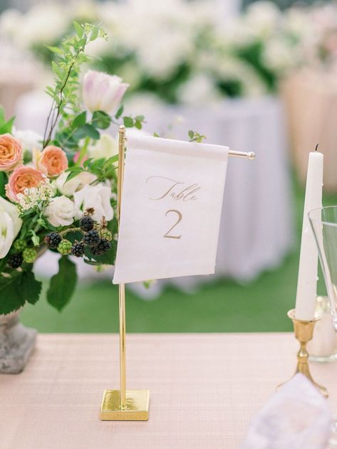 Small angled fabric table number on a tall gold Style Me Pretty stand. Off-white fabric with gold ink featuring elegant script and a modern block font table number for the Merrimon-Wynne House Winter Bridal Showcase in Raleigh, North Carolina. Photo by Alaina Ronquillo Photography. Fabric Table Numbers Wedding, Flag Table Numbers, Tall Table Numbers Wedding, Classy Table Numbers, Garden Party Table Numbers, Linen Table Numbers, Fabric Table Numbers, Wedding Stationery Checklist, Table Number Ideas