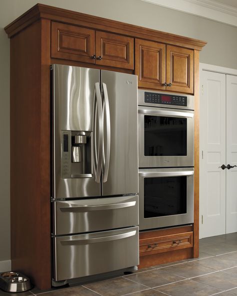 Take advantage of a larger kitchen area by building in your refrigerator and double ovens for a clean and efficient clean space.Discover All of the Martha Stewart Living Kitchens on HomeDepot.com Refrigerator And Double Oven Wall, Kitchens With Wall Ovens Layout, Double Oven Refrigerator Wall, Double Wall Oven Kitchen Layout, Kitchen With Oven In Wall, Kitchen Layout With Double Oven, Double Oven Next To Refrigerator, Refrigerator Next To Wall Oven, Refrigerator Next To Oven