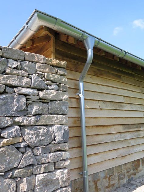 Stone And Timber Cladding, Limestone Wall Cladding Exterior, Galvanised Guttering, Cotswold Stone Extension, Weathered Larch Cladding, Oak Cladding, Porch Canopy, Copper Gutters, How To Install Gutters