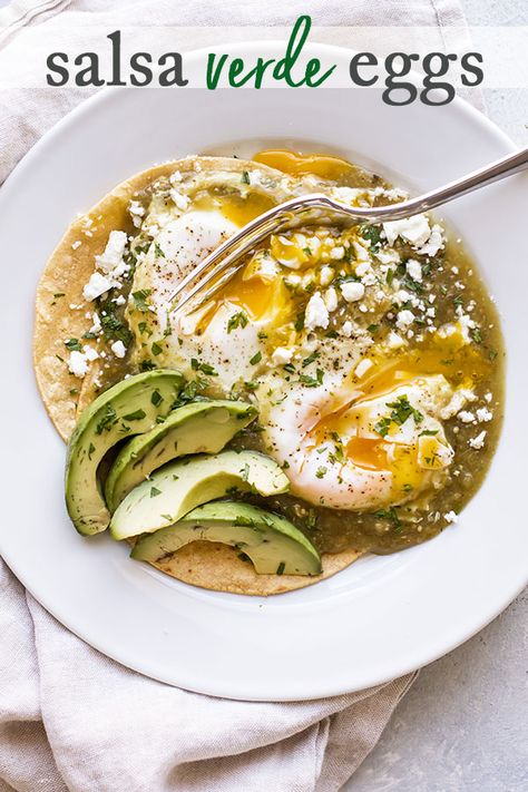 Salsa verde eggs is an easy breakfast recipe that takes 10 minutes start to finish. Warm corn tortillas topped with eggs cooked in salsa verde just until the whites are set. Add some crumbled cheese, sliced avocado and cilantro and you get a beautiful and delicious breakfast (or lunch or dinner!) for one. #eggs #corntortillas #salsa #salsaverde #fetacheese #avocado #breakfast #easyrecipe #recipesforone #cooking #quick Sauce For Eggs, Best Egg Recipes, Homemade Salsa Verde, Baked Eggs Recipe, Sliced Avocado, Easy Egg Recipes, Easy Breakfast Recipe, Mexican Breakfast Recipes, Dinner For One