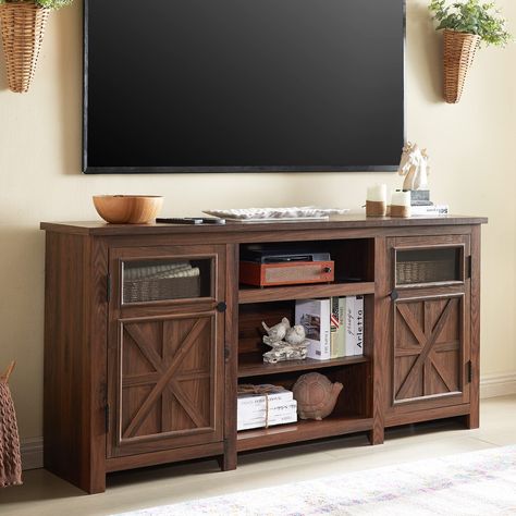 PRICES MAY VARY. FARMHOUSE STYLE TV STAND: Our 66-inch TV stand is designed in a style that blends farmhouse elements with a modern look, using a combination of vintage traditional flush doors and modern clear glass decor, with an overall structure of sleek lines for a beautifully atmospheric look. Smooth lines and a neutral colour scheme add a stylish touch to the rustic farmhouse. SPACIOUS TABLETOP: Measuring a 66"*16" roomy tabletop suitable for up to 75 inch television. There's plenty of room for family photos, potted plants and other decorations without being cramped. With a 1.18" thickened desktop that can hold 150 pounds and an overall use of premium engineered wood, this TV Console can withstand the challenges of long-term use. HUGE STORAGE SPACE: The overall 66"W x 16"D x 26"H hug Farmhouse Tv Stand Decor, 75 Inch Tv, Rustic Tv Console, Entertainment Center With Storage, Credenza Wood, Farmhouse Entertainment Center, Farmhouse Tv, Modern Tv Cabinet, Tv Stand Decor