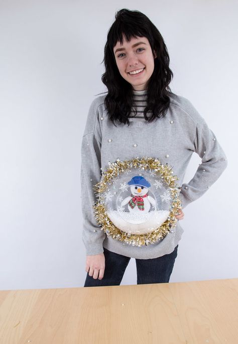 Person wearing a DIY holiday sweater with a plastic bowl and snowman stuffed animal glued to the front making it look like a snowglobe Craft Night Party, Diy Christmas Sweater, Buffalo Exchange, Marker Crafts, Snowflake Sticker, Diy Snow Globe, Holiday Sweaters, Diy Sweater, Best Stocking Stuffers