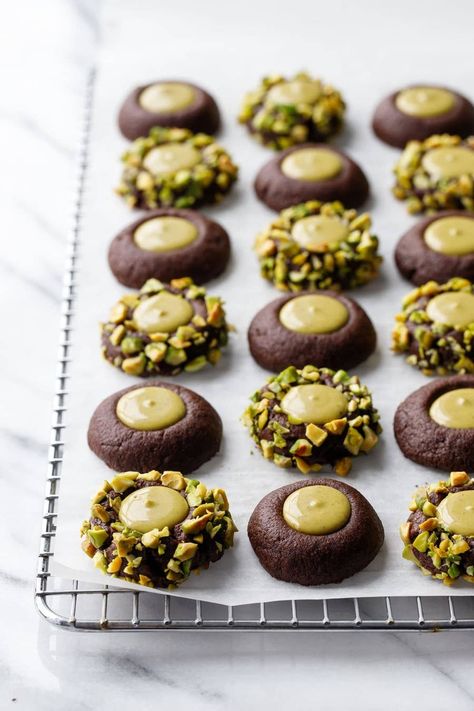 Best Things To Cook December 2022 Bakery Style Baked Goods, Chocolate Pistachio Thumbprint Cookies, Cute Chocolate Desserts, Treat Tray Ideas, Holiday Thumbprint Cookies, Recipes Using Pistachio Cream, Pistachio Butter Dessert, Recipes With Pistachio Cream, Pistachio Christmas Cookies