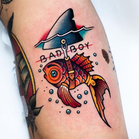 Out of Step Books & Gallery on Instagram: “Check out this awesome #badboy #goldfish #shark #tattoo that @miguelcomintattooer at @nolandtattooparlour created and who has all kinds of…” Small Traditional Tattoos For Men, Vibrant Traditional Tattoo, Quirky American Traditional Tattoos, Old School Tattoo Design Traditional Styles Flash Art, New Skool Tattoo Design, Traditional Florida Tattoo, Cowboy Shrimp Tattoo, Traditional Style Animal Tattoos, New School Tattoo Designs For Men