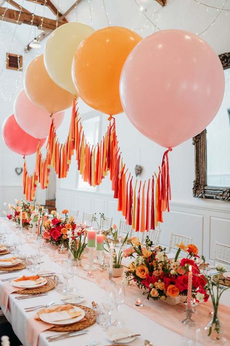 Merriscourt wedding with wedding tablescape with white wedding tablecloth, burlap place mats, tapered candles, pink and orange wedding stationery, and floral wedding table centrepieces with pink and orange garden roses, orange floribunda, yellow ranunculus flowers, foliage and Iceland poppies with red, pink orange and yellow balloons, wedding streamers and fairy lights | Sarah J Scott Photography Casual Event Decor, Colourful Wedding Decorations Diy, Tasteful Party Decorations, Event Party Decor, Balloon Tablescape, Colourful Birthday Decorations, London Wedding Theme, Simple Party Decor, Colourful Dining Room