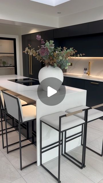 Lauren Barker on Instagram: "New flower arrangement, clean kitchen, tidy house. It’s the weekend!

Hope you all have some lovely plans! 

Our kitchen was designed by me and bespoke made! Kitchen cabinets sprayed in @farrowandball pitch black! 

Both styles of barstools are from @by_crea in light grey leather.

Long gold handles from @busterandpunch 

Kitchen floor tiles are sahara blanco from @thetilecompanyltd 

Strip lighting is linked in my Amazon storefront!

Faux flowers from @dunelmuk and @homesense_uk 

#monochrome #kitchendesign #renovation #reno #kitchengoals #kitcheninspo #modernhome #luxuryhome #homeinspo" Kitchen Floor Tiles, Waterfall Island, Tidy House, New Flower, Pitch Black, Kitchen Floor Tile, Amazon Storefront, Kitchen Floor, Gold Handles