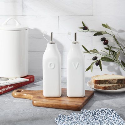 The Bistro Collection from Denmark Tools for Cooks adds elegant white style to your everyday kitchen. Decorate your counters with beautiful reusable oil and vinegar bottles and enjoy a clean, chic kitchen while you cook. This set of 2 bottles features a vintage whiteware look and durable ceramic craftsmanship, built to last for years of culinary creativity. The bottles have a classic square shape and stainless-steel nozzles for perfectly measured pouring and drizzling. Denmark | Denmark Tools fo Oil And Vinegar Bottles, Ceramic Bottles, Olive Oil Cruet, Vinegar Cruet, Olive Oil Dispenser, Brown Ceramic, Ceramic Bottle, White Shelves, Oil Dispenser