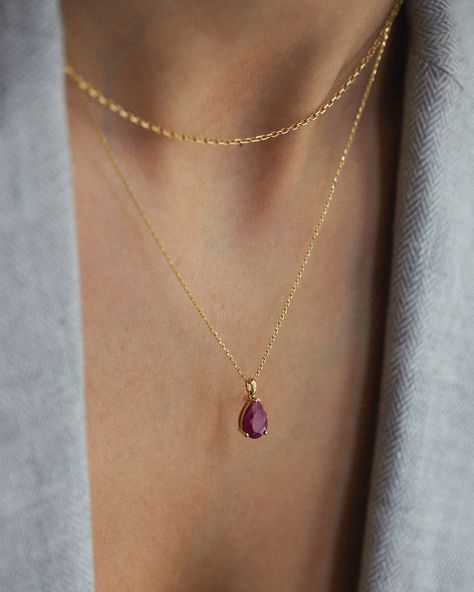 Embrace the timeless beauty of our 14K Solid Gold Ruby Pear Cut Necklace, a symphony of elegance and sophistication that transcends beyond the ordinary. This magnificent necklace contains a stunning pear-cut ruby, combined with an elegant 14K solid gold chain, creating a piece that is as unique as it is captivating. The pear-cut ruby compliments your style with timeless beauty. Its vibrant color and refined cut create a captivating sense that enchants every movement. Details: * 14K Solid Gold  * Raw Ruby Necklace, Gold Ruby Necklace, Solid Gold Chains, Ruby Necklace, Gold Diamond Necklace, Pendent Necklace, Jewelry Essentials, Jewelry Lookbook, Gold Necklace Layered