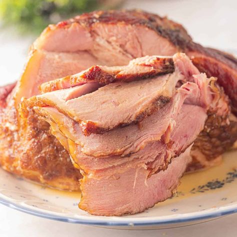 Dutch oven ham is easy to make and perfect to serve at a holiday dinner. A simple glaze adds the right amount of sweetness to this delicious baked ham. Dutch Oven Ham, Oven Ham, Spiral Cut Ham, Maple Syrup Glaze, Navy Bean Soup, Spiral Ham, Holiday Ham, Sugar Free Maple Syrup, Dutch Oven Recipes