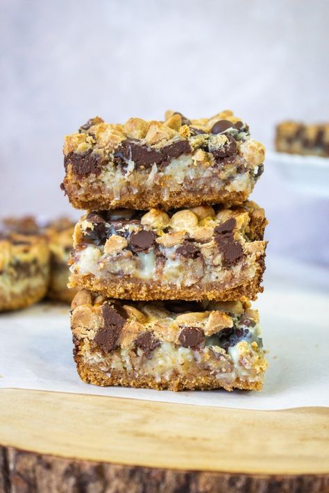 Seven Layer Magic Bars - Taffey Bakery Big Group Desserts, Take Five Bars Recipes, Magic Layer Bars, Bakeless Desserts, Taffey Bakery, Layered Bars, Peanut Butter Chocolate Cookies, Magic Bars Recipe, Seven Layer Bars