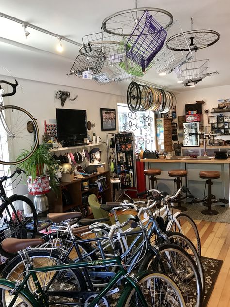 Wheels holding baskets from the ceiling at The Dropout bike shop in Reno Bike Shop Aesthetic, Bike Workshop, The Dropout, Sarah Dessen, Concept Bike, Garage Workshop Plans, Bike Shops, Workshop Plans, Coffee Bike