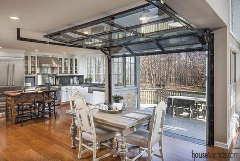 the dining space is opened to the deck with the help of garage doors Glass Garage, Glass Garage Door, Garage Remodel, Hanging Ideas, Garage Interior, Industrial Kitchen, Pole Barn Homes, Garage Design, Metal Homes