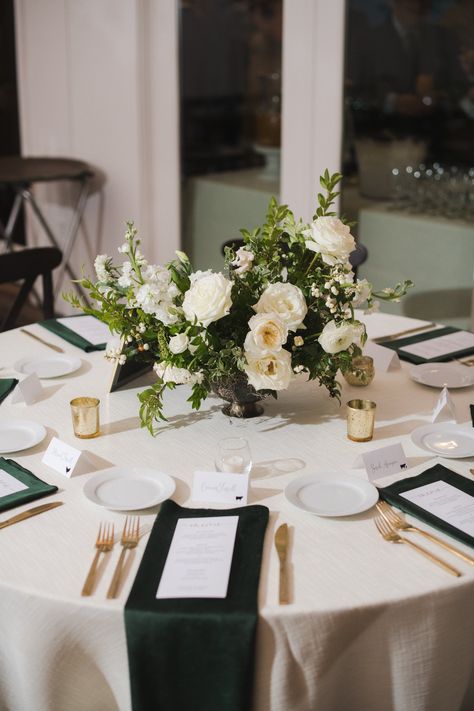 Low floral centerpieces for elegant winter wedding overflowing with white garden roses, dried hydrangeas, scabiosa, berries, lisianthus, ranunculus, and natural dark greenery. Designed by Rosemary and Finch in Nashville, TN. Low Lush Wedding Centerpieces, Winter Tablescapes Wedding, White Rose And Pine Centerpiece, Wedding Flowers White And Green Centerpieces, Green And White Wedding Round Table Decor, White Floral Centerpieces Wedding Low, White And Green Winter Wedding Centerpieces, Green And White Wedding Centerpieces Round Table, All White Wedding Tablescape