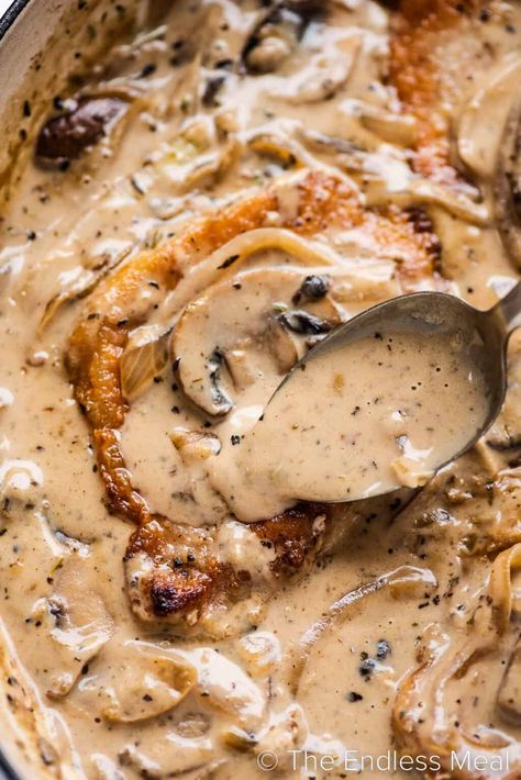 Tender smothered pork chops are pan-seared to golden perfection and then served in a savory onion and mushroom gravy. Not only is this one of our favorite ways to prepare pork chops, but it's also a quick and easy recipe for weeknights. Ready in just 25 minutes! #theendlessmeal #porkchops #smotheredporkchops #porkchopsmushrooms #porkchoprecipe Mushroom Gravy Pork Chops, Onion And Mushroom Gravy, Mushroom Onion Gravy, Cheesy Pork Chops, Pork Chop Dishes, Oven Pork Chops, Smothered Pork Chops Recipe, Pork Chop Recipes Crockpot, Mushroom Pork Chops