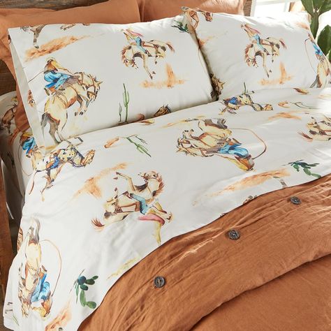 PRICES MAY VARY. BRONCO WESTERN VINTAGE COWBOY SHEET SET: features western icons of bronco-riding cowboys in the desert in warm tones of rust, gold, with pops of blue and green on a warm cream background. The timeless cowboy and bronco design makes this sheet set the perfect way to finish your bedset. SOFT AND COMFORTABLE LUXURY: Made from the softest cotton, this sheet will never feel heavy, stiff or uncomfortable. Our Bronco Vintage Western Cowboy sheets have an ultra soft feel that you will s Western Bunk Beds, Modern Western Room Decor, Ranch House Bedroom Decor, Little Boy Cowboy Room, Bright Western Decor, Western Bed Sheets, Retro Western Bedroom, Brother And Sister Shared Room, Western Pop Up Shop