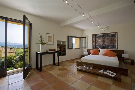 Large terra-cotta tile brings country charm to the luxurious contemporary bedroom [Design: Ernesto Santalla] Tiles Floor Bedroom, Floor Bedroom Ideas, Mediterranean Bedroom, Decoration For Ganpati, Terracotta Floor, Gorgeous Tile, Floor Tile Design, Elegant Bedroom, Comfortable Bedroom