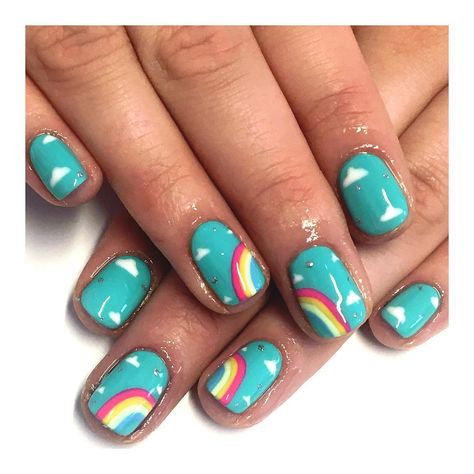 Short Nails: Taste the Rainbow. A blue base accented with rainbow designs. Click through for 30 short nail ideas. #shortnails #shortnailideas #manicureideas #nailart IG: @nailsby_eleanor Green Rainbow Nails, White Nails With Rainbow Designs, Rainbow Gel Nails Short, Nails With Rainbow Design, Designs For Short Natural Nails, Rainbow Short Nails, Rainbow Nails Short, Little Kid Nails, Kendall Nails