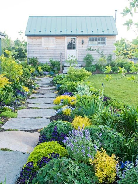 Purples and yellows supply a flowerbed with subdued color.Narrower beds are easier to access from both sides, making them easier to maintain.Repeating plants and colors, shown here in a planting of cranesbill and coralbells, fills a pretty flower border.Mounding plants maintain a view of the rest of the garden.To create a more casual appeal to the garden, flowers and shrubs are left to grow in a natural pattern.The foliage of bearded iris offers vertical visual interest to the garden. Walkways Paths, Stone Path, Have Inspiration, Garden Pathway, Architecture Portfolio, Landscape Projects, Garden Cottage, Front Garden, Garden Styles