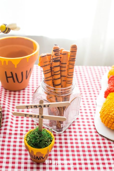 This DIY Winnie the Pooh birthday party is too cute! With tons of Winnie the Pooh birthday party ideas, this is your Winnie the Pooh birthday party guide. Happy birthday, little one! It'd make a great Winnie the Pooh baby shower, too. Diy Winnie The Pooh, Literary Food, Winnie The Pooh Birthday Party, Pooh Birthday Party, 40 Aprons, Pooh Halloween, Disney Trivia, Pooh Party, Winnie The Pooh Themes