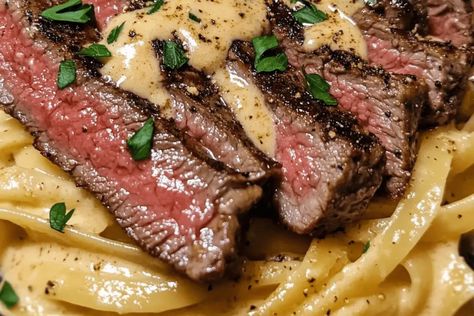 Try this Creamy Cajun Steak Alfredo! Tender steak, fettuccine, and a spicy Alfredo sauce make for a rich, flavorful, easy dinner in 35 min. Creamy Steak Fettuccine Delish, Spicy Cajun Steak With Creamy Alfredo, Steak And Fettuccine, Spicy Cajun Steak Alfredo Pasta, Cajun Steak Pasta Recipes, Creamy Cajun Steak Pasta, Steak Shrimp Alfredo Pasta, Cajun Steak And Shrimp Alfredo Pasta, Steak Pasta Sauce