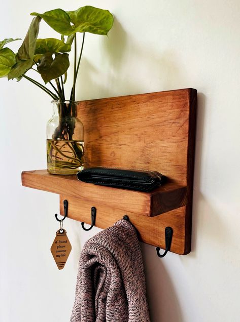 Simply designed key hook shelf can help keep you organized with style! 4 study black hooks that can also hold coats, scarves and hats with a shelf for décor, wallets, sunglasses or anything else you need a place for. Handmade out of solid pine and available in 2 colors or DIY no stain color option. This product is finished with no VOC chemicals, learn more below!Available Colors:Auburn Brown: This color picks up all the natural undertones of the pine wood and enhances a warm red undertone throug Key Hook Shelf, Entryway Coat Hooks, Hook Shelf, Shelf Entryway, Key Holder Wall, Entryway Hooks, Black Hooks, Auburn Brown, Candle Wall Decor