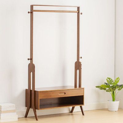 This garment rack is made of excellent bamboo, which is sturdy and durable. Its stable triangular brackets on both sides allow you to hang all kinds of clothes without shaking. It comes with a large drawer and enough space underneath the drawer to store your jewelry, books, and other miscellaneous items. It combines functionality and stylish design. It can be placed in entryways, hallways, bedrooms, living rooms, cashier rooms, etc. | Red Barrel Studio® 32.9" Solid + Manufactured Wood Clothes Ra Extra Clothes Storage Ideas, Diy Clothes Rack Wood, Clothes Rack Ideas, Garment Rack Bedroom, Clothes Hanger Wood, Wood Clothes Rack, Clothes Rack Design, Wood Clothing Rack, Cloth Stand