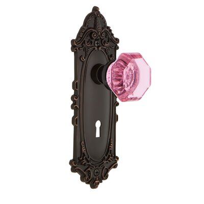 The Waldorf Privacy Door Knob with Victorian Plate with its distinct curvilinear embellishment is unmistakably old world vogue. Pair this with Nostalgic Warehouse Waldorf Door Knob and its crisp clean edges for a lucent look. All Nostalgic Warehouse door knobs are mounted on a solid (not plated) forged brass base for durability and beauty. Finish: Timeless Bronze, Backset: 2-3/4” | Nostalgic Warehouse Pink Crystal Waldorf Privacy Door Knob w / Keyhole Victorian Long Plate in Brown, Size 8.25 H x Black And Pink Gothic Bedroom, Waldorf Interior, Crystal Door Knobs, Privacy Door, Pink Door, Goth Home, Goth Home Decor, Gothic Home Decor, Gothic House