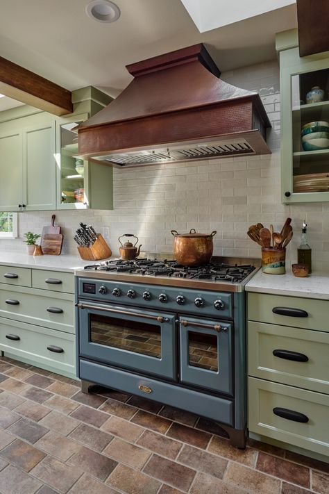 -- CORVALLIS, OR -- This kitchen showcases distinct custom-made items, including a striking chandelier, dining table, and a large copper range hood. A stunning copper corner sink, 48” Italian range, and the integrated (paneled) appliances are  unique features that make this space so exceptional. Kitchen Stove Area Ideas, Recessed Stove Kitchen, Copper Hood, Copper Range Hood, Corner Sink, Cooker Hoods, Kitchen Stove, Range Hoods, Range Hood