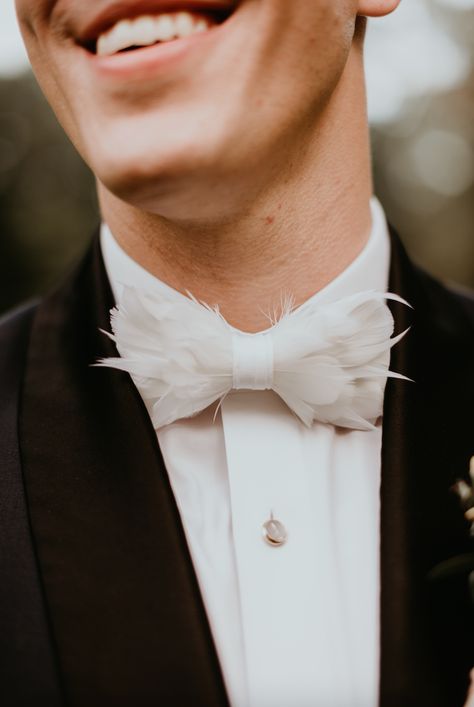 How cool is this unique feather bowtie for the alternative groom style? We love the addition of creative accessories for wedding attire! Just look at the texture on that bow tie. Check our more wedding accessory ideas on our blog. Grooms Accessories Wedding, Feather Bow Tie Wedding, Wedding Accessories For Groom, Groom Suit Bow Tie, Unique Groom Attire, Alternative Groom Attire, Feather Bowtie, Alternative Groom, Southern Wedding Traditions