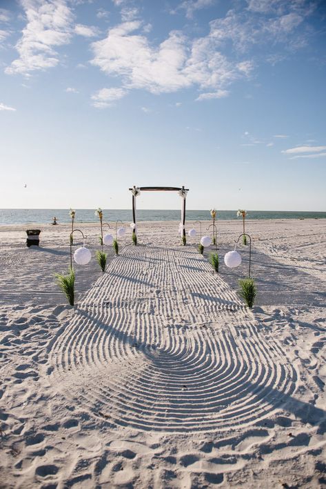 Simple Intimate Beach Wedding Ceremony Decor with White Pomander Balls on Iron Hook with Greenery, Black Tulle Draped Table, Wooden Arch with White FLowers and Draping, and Tiki Torches | Tampa Bay Wedding Planner Gulf Beach Weddings | Treasure Island Venue Sunset Vista Condo Hotel Resort Beach Wedding Ceremony Decor, Small Beach Weddings, Sunset Beach Weddings, Beach Wedding Locations, Beach Wedding Ceremony, Simple Beach Wedding, Wedding Ceremony Decor, Dream Beach Wedding, Madeira Beach