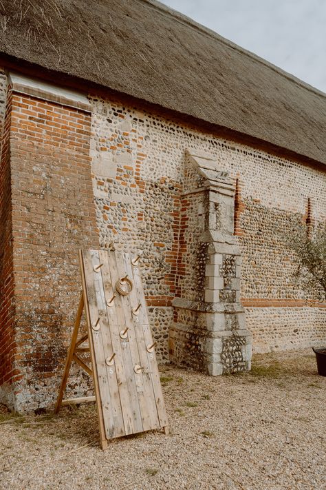 This shows an outside of a barn. There is a tall rustic wooden door quoits game displayed. Sacrifice Aesthetic, Barn Photography, Rustic Door, Garden Games, Modern Games, Rustic Doors, Photography Games, Wedding Games, Wooden Garden