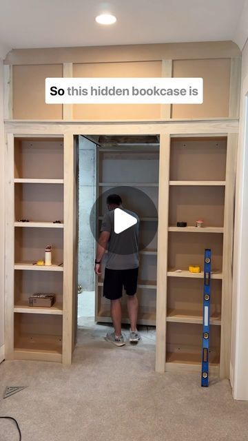 MT Trim Co. on Instagram: "This hidden bookcase door is on another level! It’s literally hanging from tracks that help it glide completely in and out of the opening! 

#hiddendoor #bookcase #slidingdoors #carpentryskills #interiortrim #customcabinets #slide #builtins" False Bookshelf Door, Built In Bookshelves With Hidden Door, Built Ins With Secret Door, Hidden Christmas Tree Closet, Library Hidden Door, Hidden Track Sliding Door, Hidden Book Shelf, Hidden Bookcase Door, Diy Bookshelf Wall