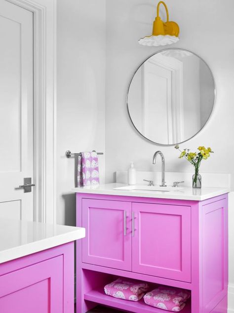 “My clients wanted their home to feel custom, so we chose vibrant paints like this pink. The color gets their daughters excited to brush their teeth, plus it reflects off the walls and makes the entire bathroom glow.” — Denise Davies, D2 Interieurs, Weston, CT Hot Pink Cabinets, New Orleans Apartment, Pink Cabinets, Yellow Dining Room, Warm Paint Colors, Shade Ideas, Hgtv Designers, Woodland House, Hgtv Star