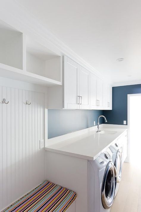 White and blue galley style mudroom and laundry room features a white front loading washer and dryer enclosed beneath a white quartz countertop and beside white cabinets finished with a sink and a polished nickel gooseneck faucet. Galley Laundry Room, Galley Laundry, Small Utility Room, Laundry Mudroom, Blue Laundry Rooms, Mudroom Laundry, Oregon House, Mudroom Laundry Room, Laundry Room Bathroom