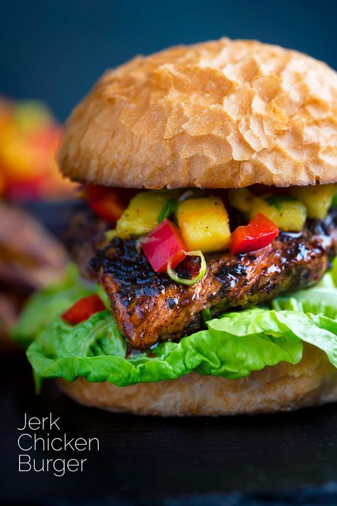 This jerk chicken burger is a spicy hot treat featuring classic Jamaican seasonings and comes with a light and refreshing mango salsa. Each element can be prepared separately and they are just as good grilled on the BBQ as they are in a skillet. Jerk Chicken Sandwich, Jamaican Seasoning, Bean And Cheese Burrito, Spicy Burger, Jerk Chicken Recipe, Jamaican Jerk Chicken, Chicken Burgers Recipe, Cooked Chicken Recipes, Jamaican Jerk