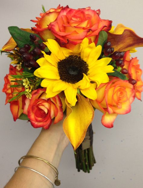 Bright orange and yellow bridesmaid bouquet including roses, sunflowers, mini calla lilies, and hypericum berries. Perfect for a fun and colorful look Yellow Wedding Bouquet, Sunflowers And Roses, Sunflower Themed Wedding, Sunflower Wedding Bouquet, Hypericum Berries, Sunflower Bouquets, Feather Wedding, Fall Wedding Bouquets, Fall Wedding Flowers