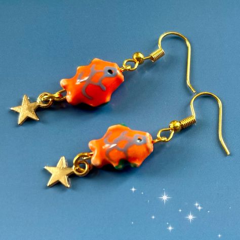 Japanese painted bead gold  koi fish earrings. Unique to my shop! Cute mini ceramic bead koi fish carp star earrings. The koi fish has long been known as a lucky symbol of good fortune.  These earrings feature a unique design that is my own design making them a one-of-a-kind gift for your loved ones. The cute ceramic fish on the earrings are seen swimming upstream against the current, symbolizing perseverance and strength.  Measuring at 1.5cm x 1 cm the charm size is perfect for making a splash Cute Japanese Accessories, Clay Fish Earrings, Gold Koi Fish, Gold Koi, Japanese Earrings, Funky Accessories, Zen Gifts, Family Peace, Fish Beads