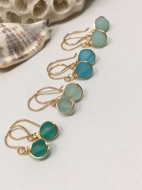 A minimal yet luxurious design featuring beautiful, cultured sea glass. These colors are so gorgeous and translucent they look like they glow from within! These cultured sea glass beads are 6mm in size Each shade of blue is reminiscent of the crystal blue waters in exotic regions of the world. The design is kept subtle with a dainty herringbone wrap and a finished with a hand-forged French ear wire. #christmasgiftideas #christmasgiftforher #giftsforher Foam Earrings, Sea Glass Beads, Beachglass Jewelry, Sea Glass Earrings, Diy Wire Jewelry, Wrap Jewelry, Wire Work Jewelry, Jewellery Ideas, Handmade Wire Jewelry