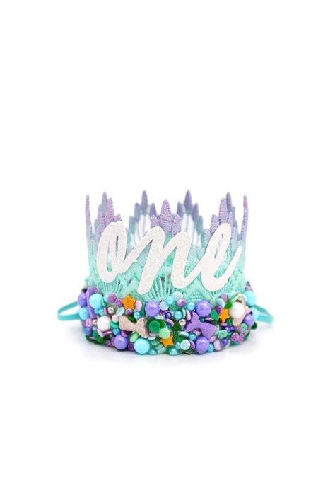 PRICES MAY VARY. d e t a i l s: Dive into the world of sweetness + fun with our Mermaid Sprinkles Birthday crown. This stunning lavender + aqua ombre lace crown is adorned with a beautiful mix of real candy sprinkles + sparkles {sealed on for longevity}, a sparkly white"one" cursive lettering, and a coordinating elastic headband. s i z e + f i t : Crown measures : 2.5" tall x 3" wide. Adjustable skinny elastic headband is meant to be worn around the back of the head and NOT under chin. p a c k a Diy Mermaid Birthday Party, Mermaid Tiara, Oneder The Sea, Mermaid First Birthday, First Birthday Crown, Lace Crown, Lace Crowns, Mini Crown, Birthday Inspiration