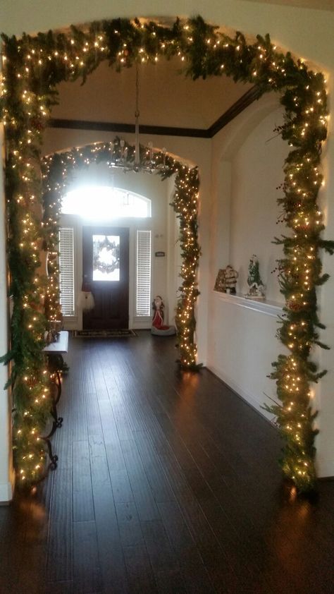 Decorated Archways Home, Front Entryway Christmas Decor, Hallway Arch Christmas Decorating Ideas, Entryways Decorated For Christmas, Arched Doorway Christmas Decor, Entry Way Christmas Trees, Christmas Decor Ideas For Hallway, Arch Christmas Decorations Entryway, Arch Way Christmas Decorations