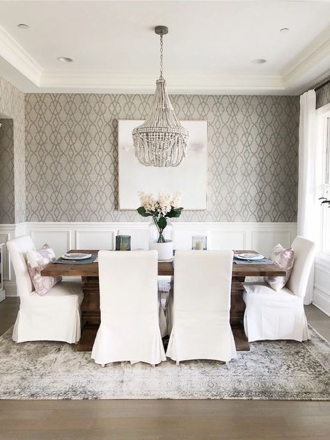 See all of the details of this lovely traditional dining room. This neutral dining room has it all and the post is full of sources, too! Slipcovered Dining Room Chairs, Beaded Chandelier Dining Room, White Slipcovered Chair, Restoration Hardware Dining Room, Wallpaper Dining Room, Wallpaper Dining, Vintage Inspired Rugs, Neutral Dining Room, Interior Design Dining