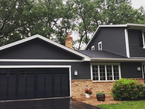 Hardie siding in Iron Gray, white trim, black garage door with red orange brick Dark Gray House Exterior Black Garage Doors, Dark Grey Siding With Brick, Siding With Orange Brick, Dark Siding With Brick, Dark Grey House With White Trim, Dark Gray Siding Black Garage Door, Dark Gray And White Exterior House, Black Exterior With White Trim, Gray Siding With Brick