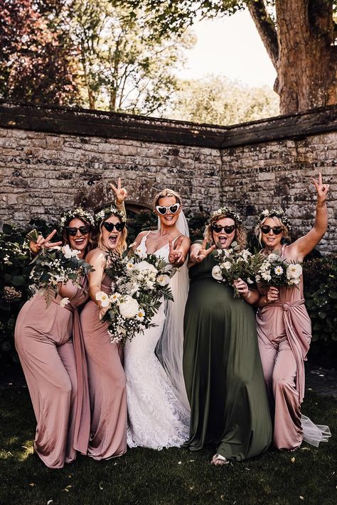 Bridal party in white heart shaped sunglasses, a lace wedding dress and pink and green bridesmaid dresses Bridesmaid Dresses Sage Green And Blush, Dark Green And Pink Bridesmaid Dresses, Sage Green And Blush Wedding Bridesmaid Dress, Pink Green Bridesmaid Dresses, Sage Green Dusty Blue Blush Pink Bridesmaid Dresses, Blush Pink And Olive Green Wedding, Sage Green And Blush Pink Bridesmaid Dresses, Wedding Colors Pink And Green, Dusty Pink And Emerald Green Wedding