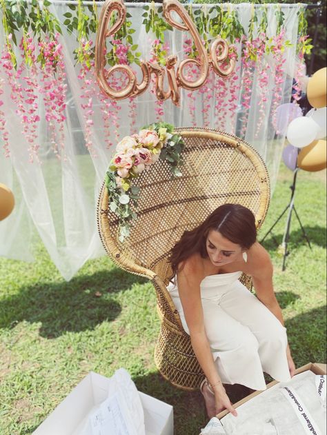 Peacock chair, silk floral arrangement, wisteria, tulle backdrop, gift opening Bridal Shower Present Opening Chair, Peacock Chair Flowers, Peacock Chair Floral Arrangement, Bridal Shower Opening Gifts Chair, Bridal Shower Peacock Chair, Bride Chair At Shower Diy, Bridal Shower Gift Chair, Bridal Shower Bride Seat, Peacock Chair Bridal Shower Ideas