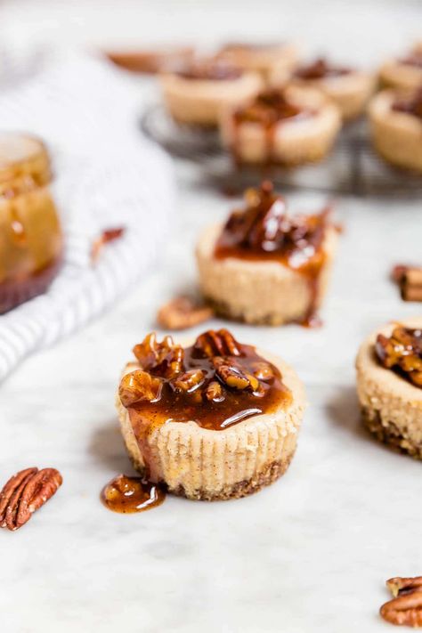 These mini pecan pie cheesecakes are gluten-free and grain-free with a spiced pecan crust and topped with a decadent pecan pie caramel sauce. Perfect for holiday entertaining! They're easy to make ahead and a delicious dessert for any party, whether you're hosting or bringing a dish to share. Skip the graham crackers and go with a pecan crust for these easy mini cheesecakes spiced with cinnamon. #glutenfree #entertaining #grainfree Easy Mini Cheesecakes, Mini Pecan Pie, Mini Cheesecakes Easy, Individual Cheesecakes, Pecan Crust, Mini Pecan Pies, Pecan Pie Cheesecake, Gluten Free Thanksgiving, Gluten Free Desserts Recipes